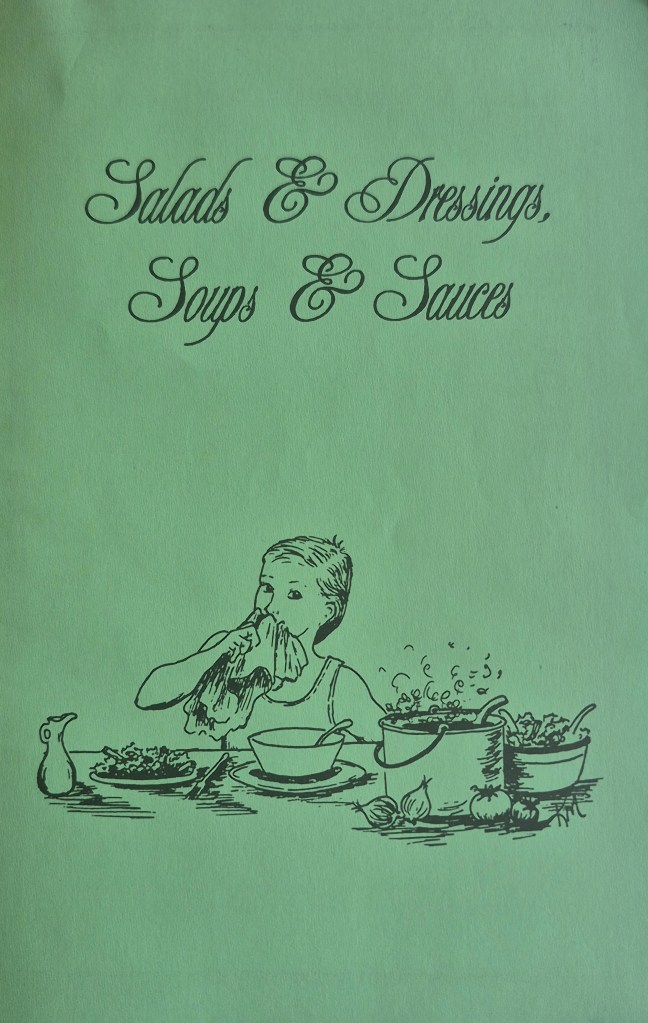 Salads and dressings, soups and sauces artwork. A woman wipes her mouth with a soup bowl in front of her. There is a salad and a pot of something hot in front of her. By Kathy McGill.